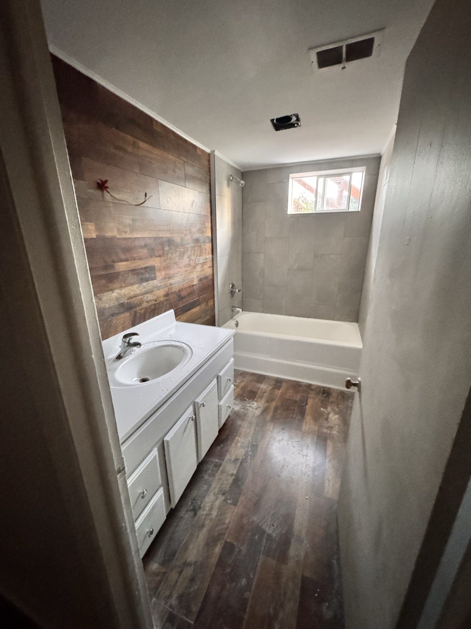 Finished bathroom with wood-look tile floor