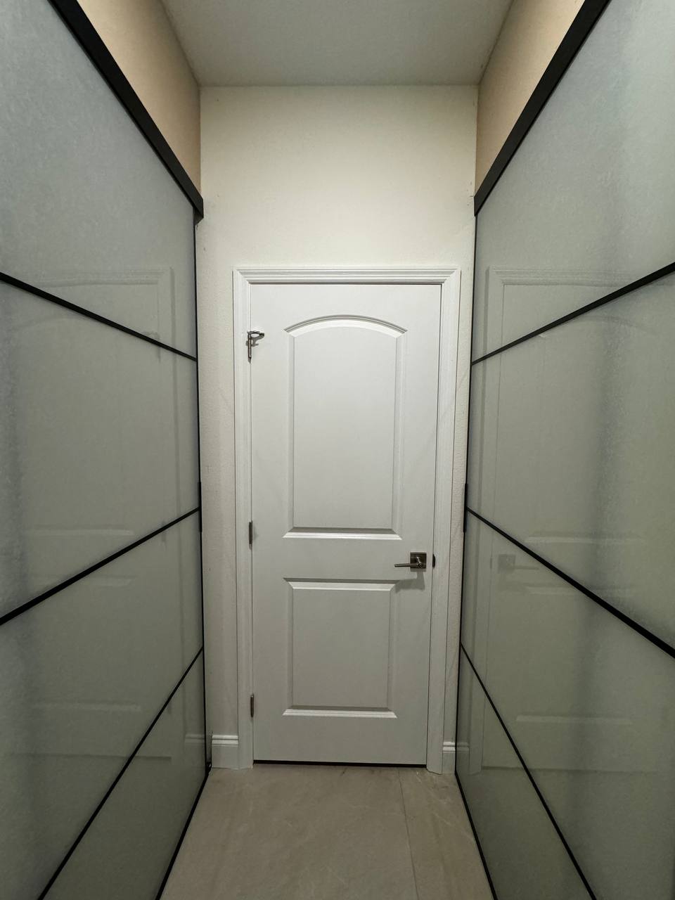 Custom closet with glass panel doors
